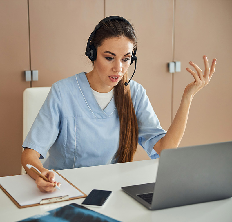 female doctor helping patient over video chat